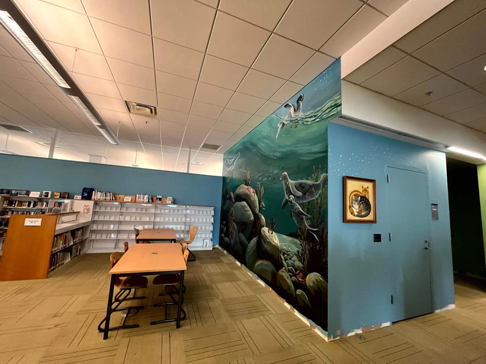 LOCAL PAINTERS IN PORTLAND, ME highlighting a professionally painted commercial library interior with a detailed aquatic mural and clean, modern finishes completed by Zellers Painting & Contracting.