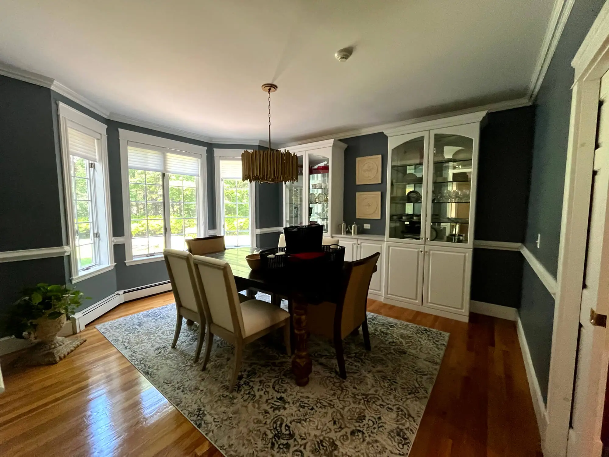 Refined dining room featuring smooth gray walls, crisp white trim, and built-in cabinetry expertly painted by Zellers Painting & Contracting.