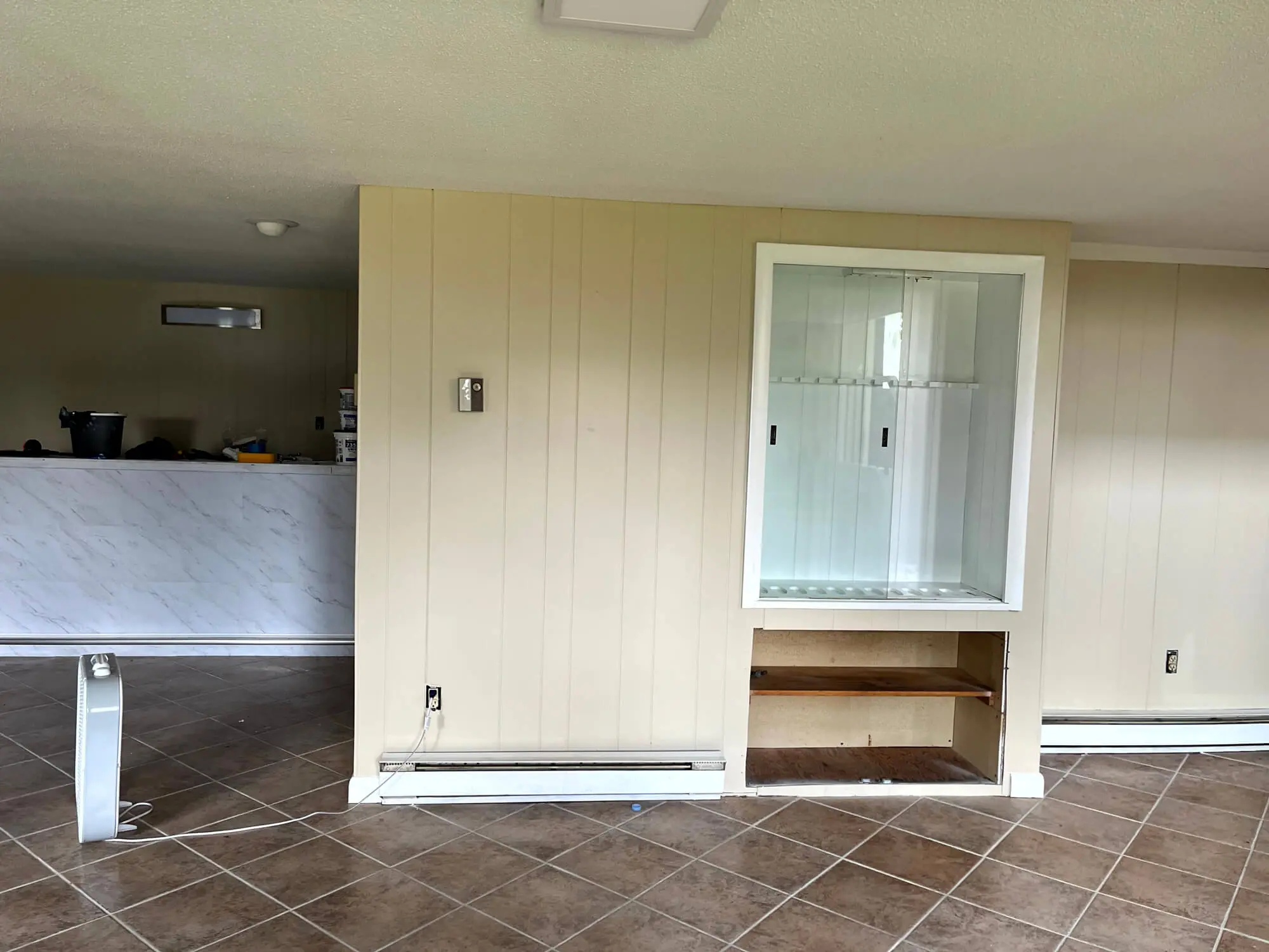 Professionally painted interior space with smooth neutral panel walls, clean trim, and a refreshed built-in cabinet area completed by Zellers Painting & Contracting.