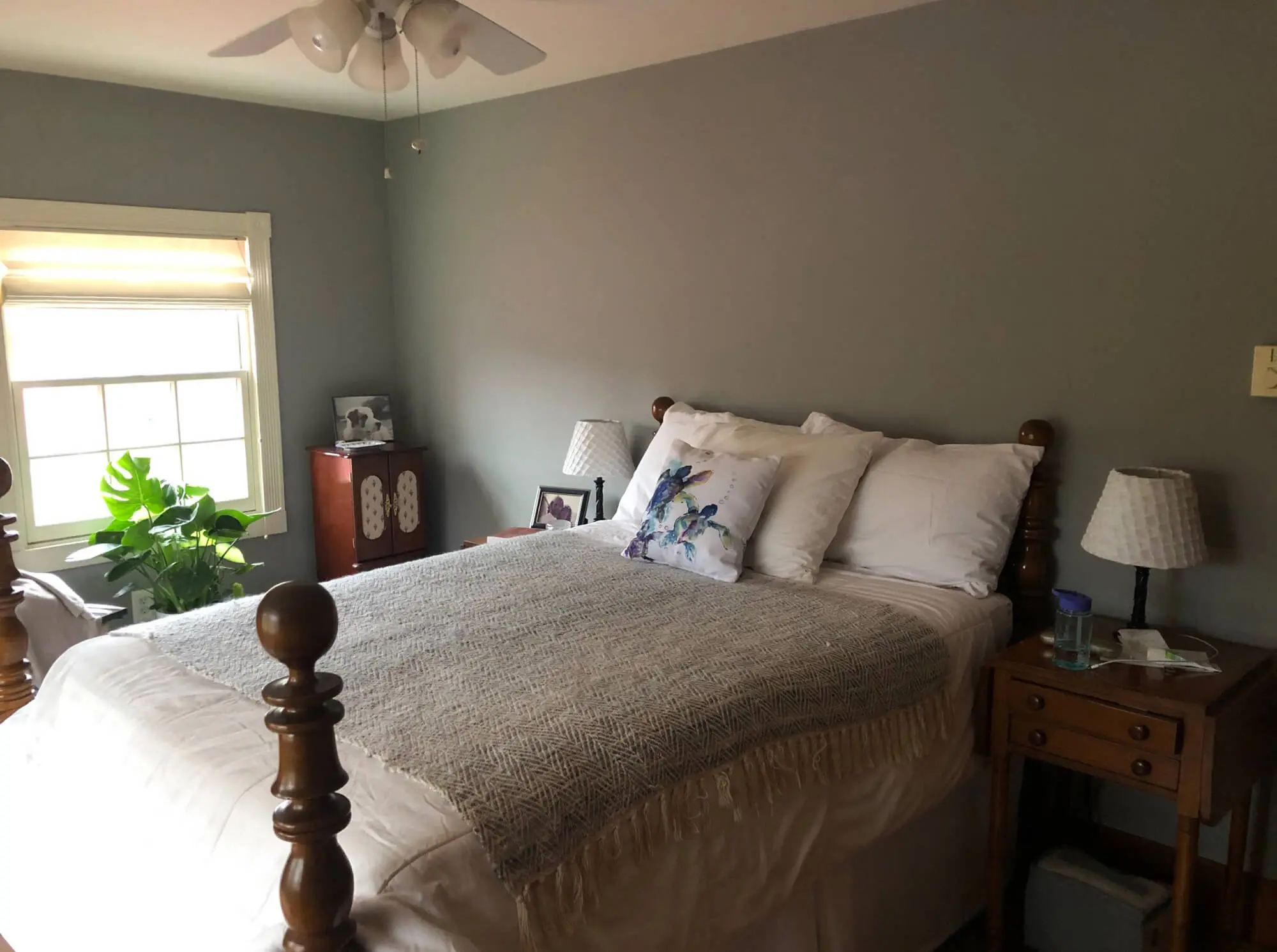 Calm bedroom interior featuring smoothly painted gray walls and a clean, even finish that enhances comfort and style, completed by Zellers Painting & Contracting.