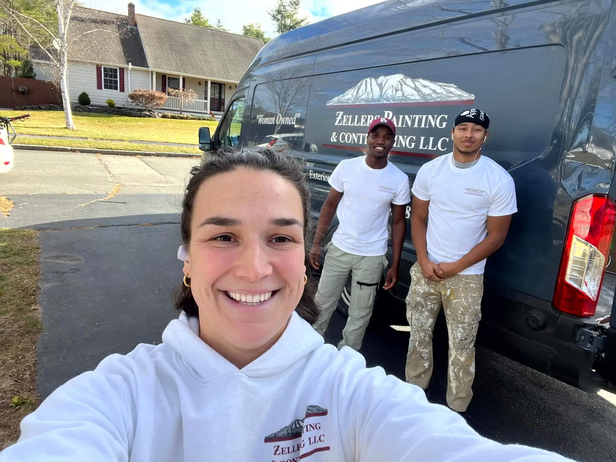 rebekah zellers owner of zellers painting and her team in front of their painting company truck portland me